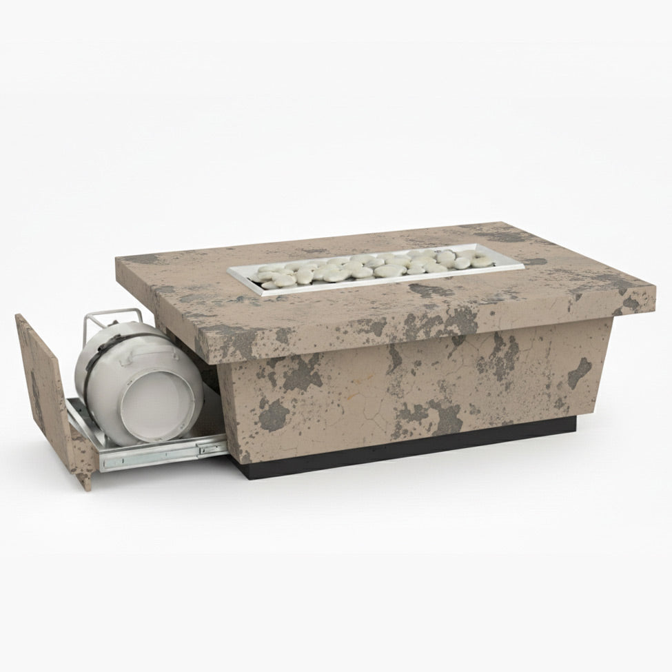 A rectangular outdoor fire table in light basal antique finish with a concrete tabletop and a visible propane gas burner system beneath it.